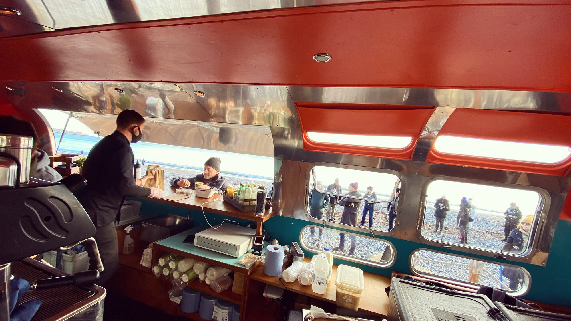 The Airstream interior with coffee being served.