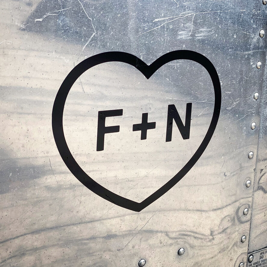 Black F + N decal applied to the Airstream metal.