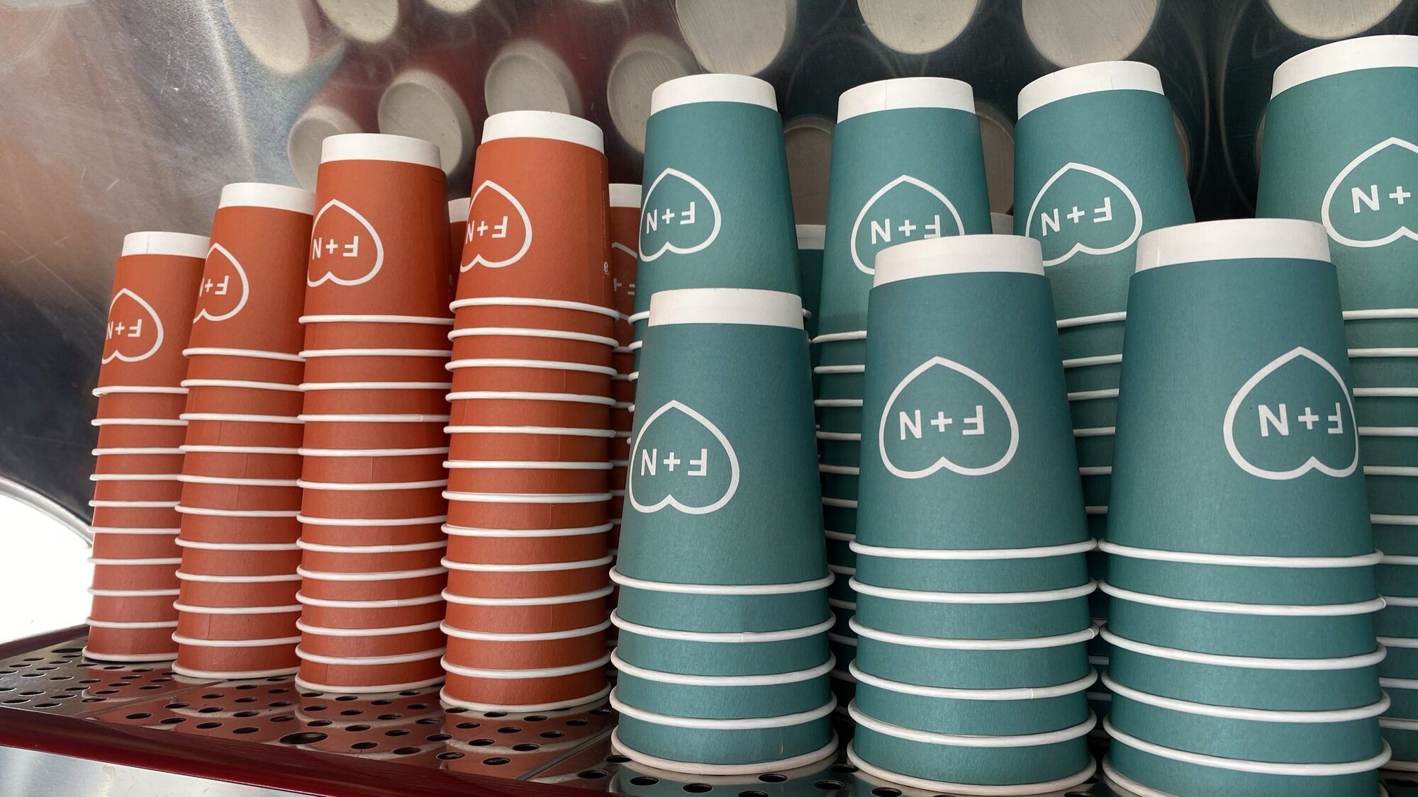 Stacks of branded coffee cups.
