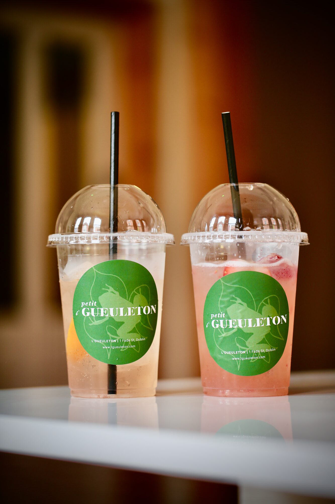 Takeaway drinks with branded green labels.