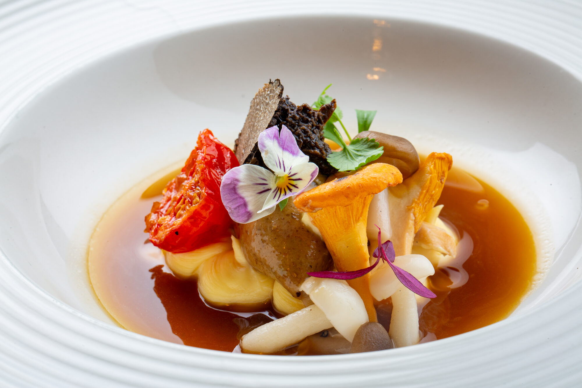 A plated dish at Luna — broth and mushroom, garnished.