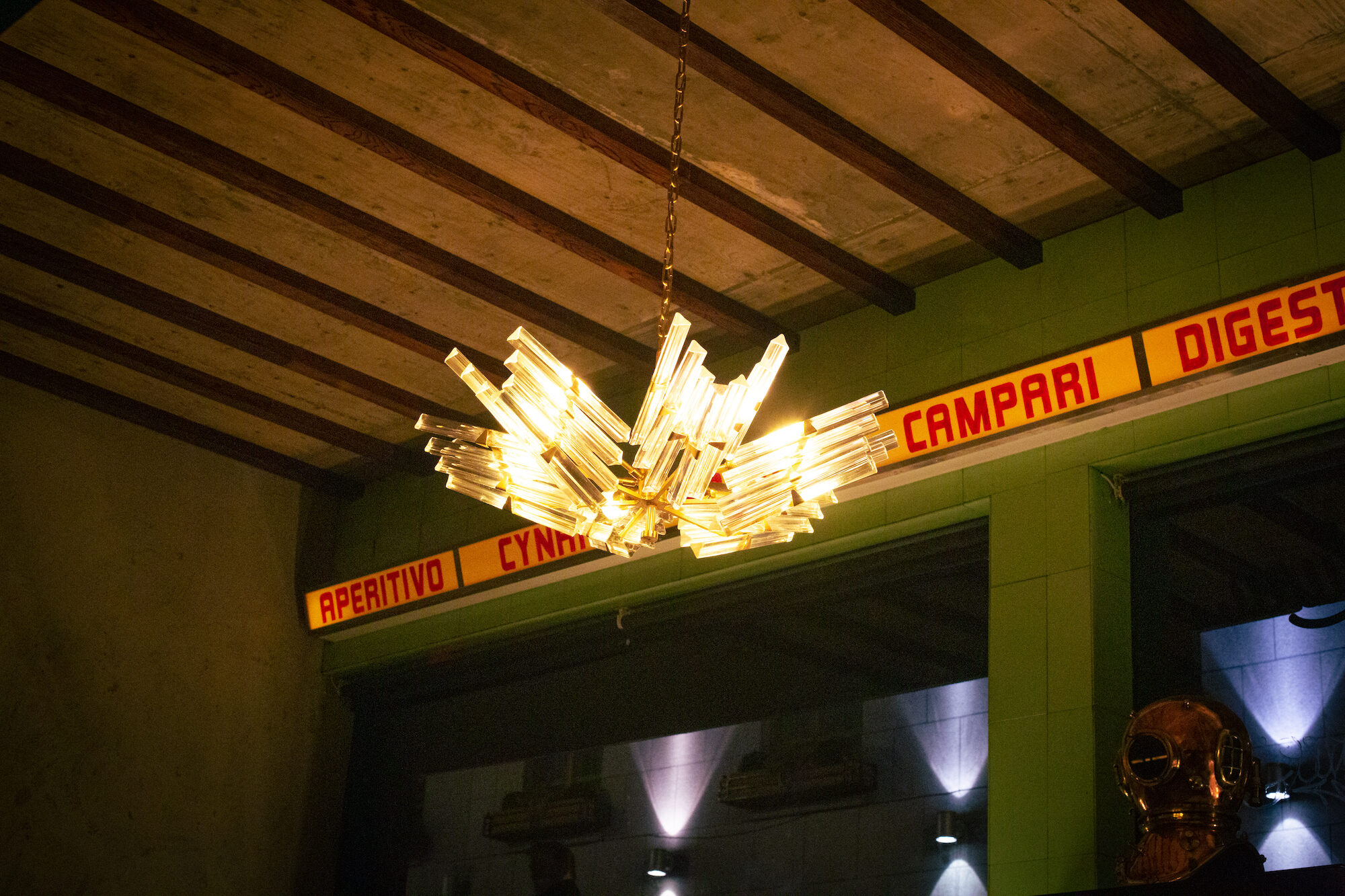 A chandelier with a Campari bottle — atmospheric detail.