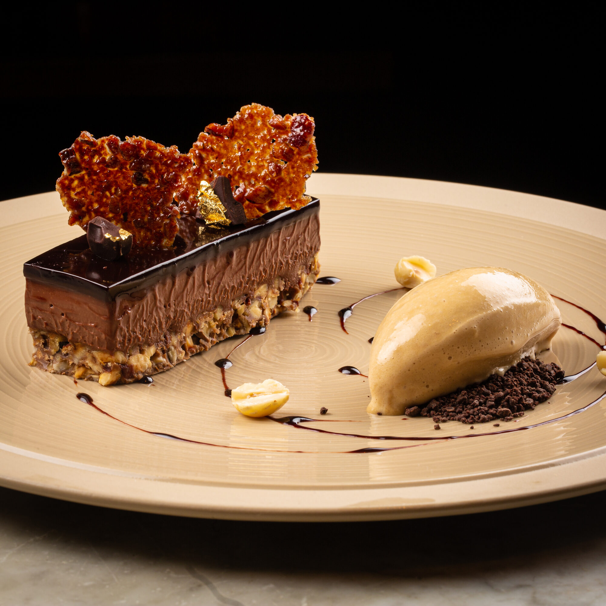 Chocolate dessert with ice cream, crumb and crisp garnish.
