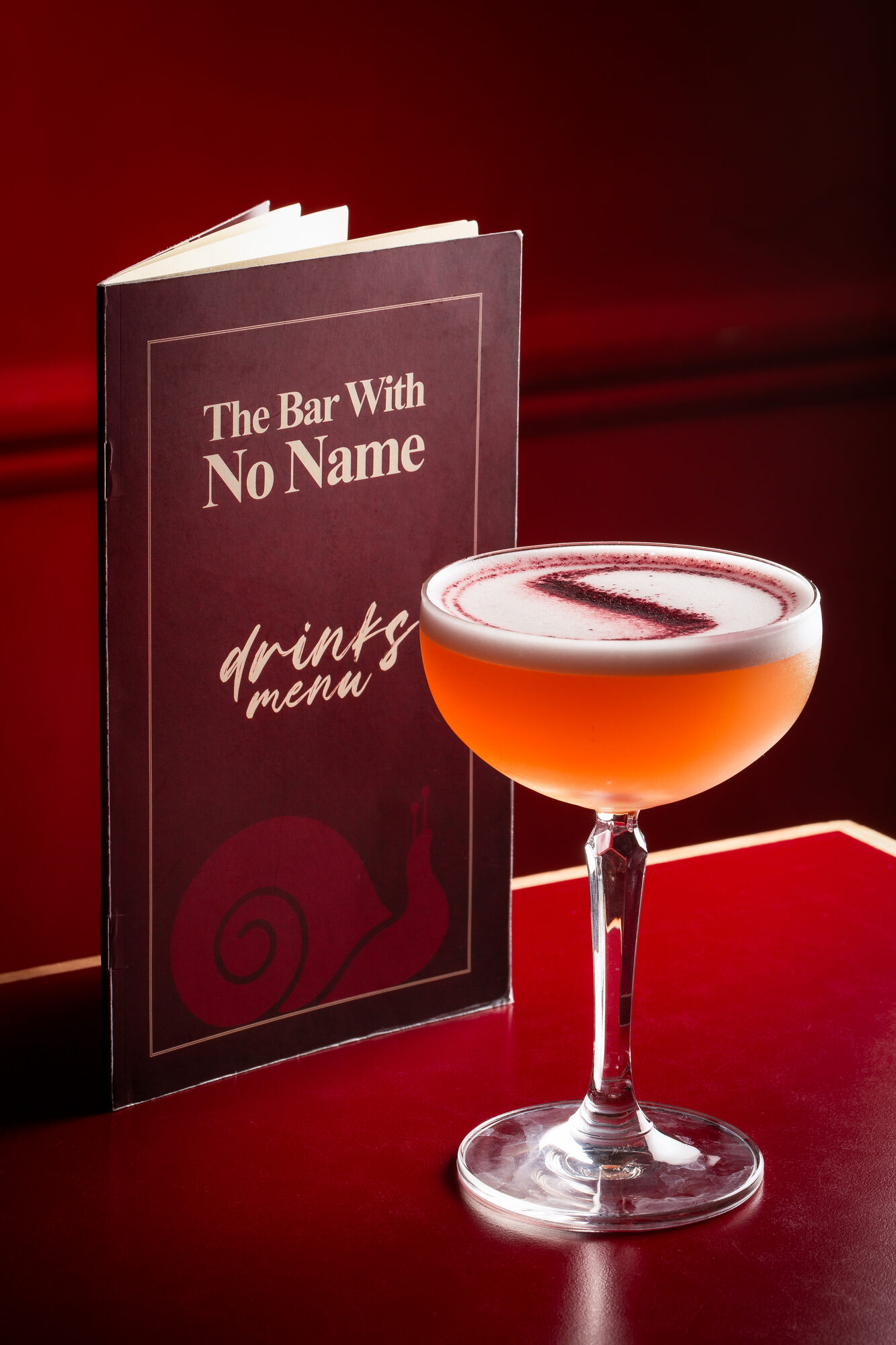 The drinks menu cover in oxblood red.