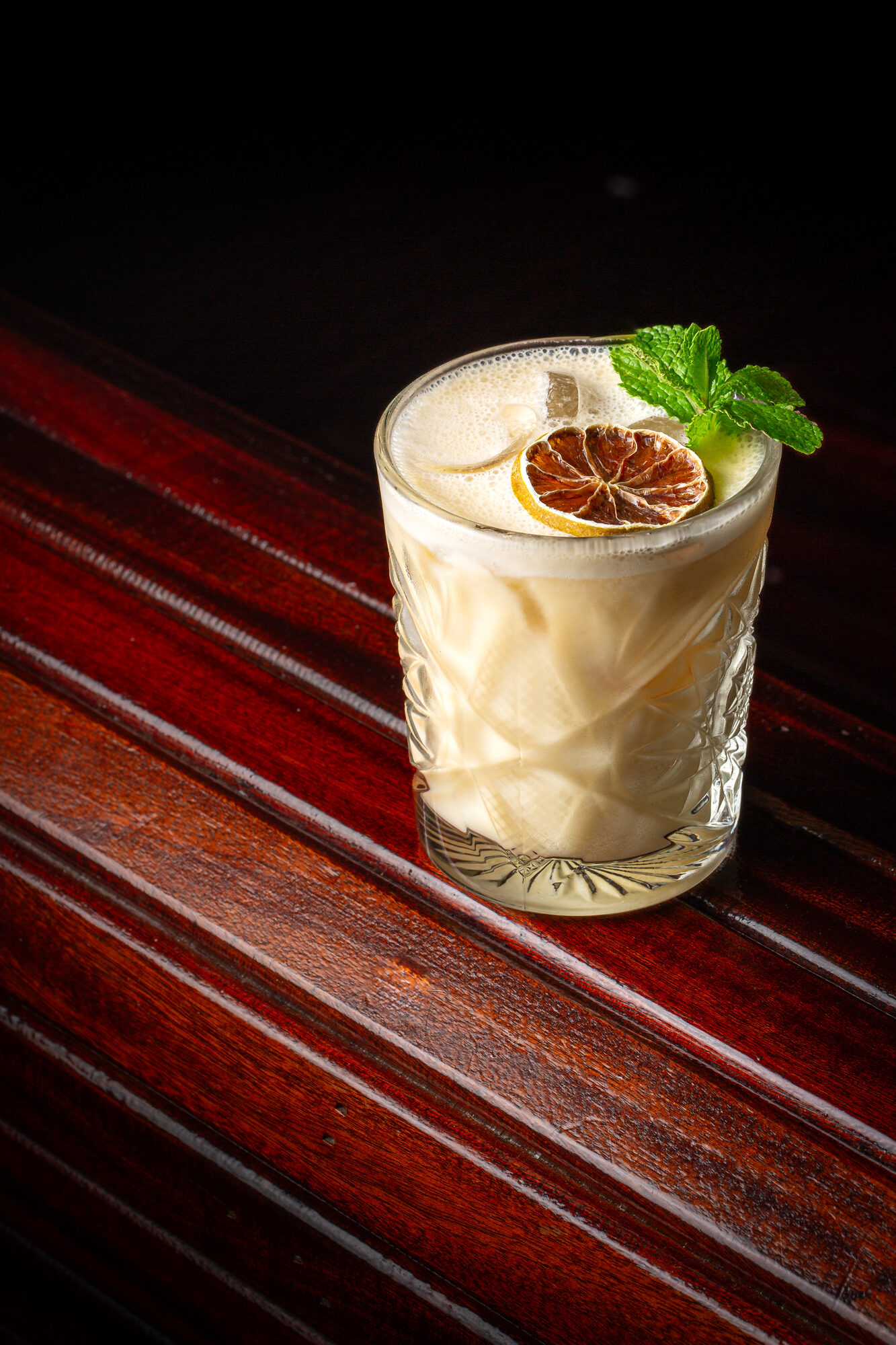 Creamy mint cocktail in a dark setting.