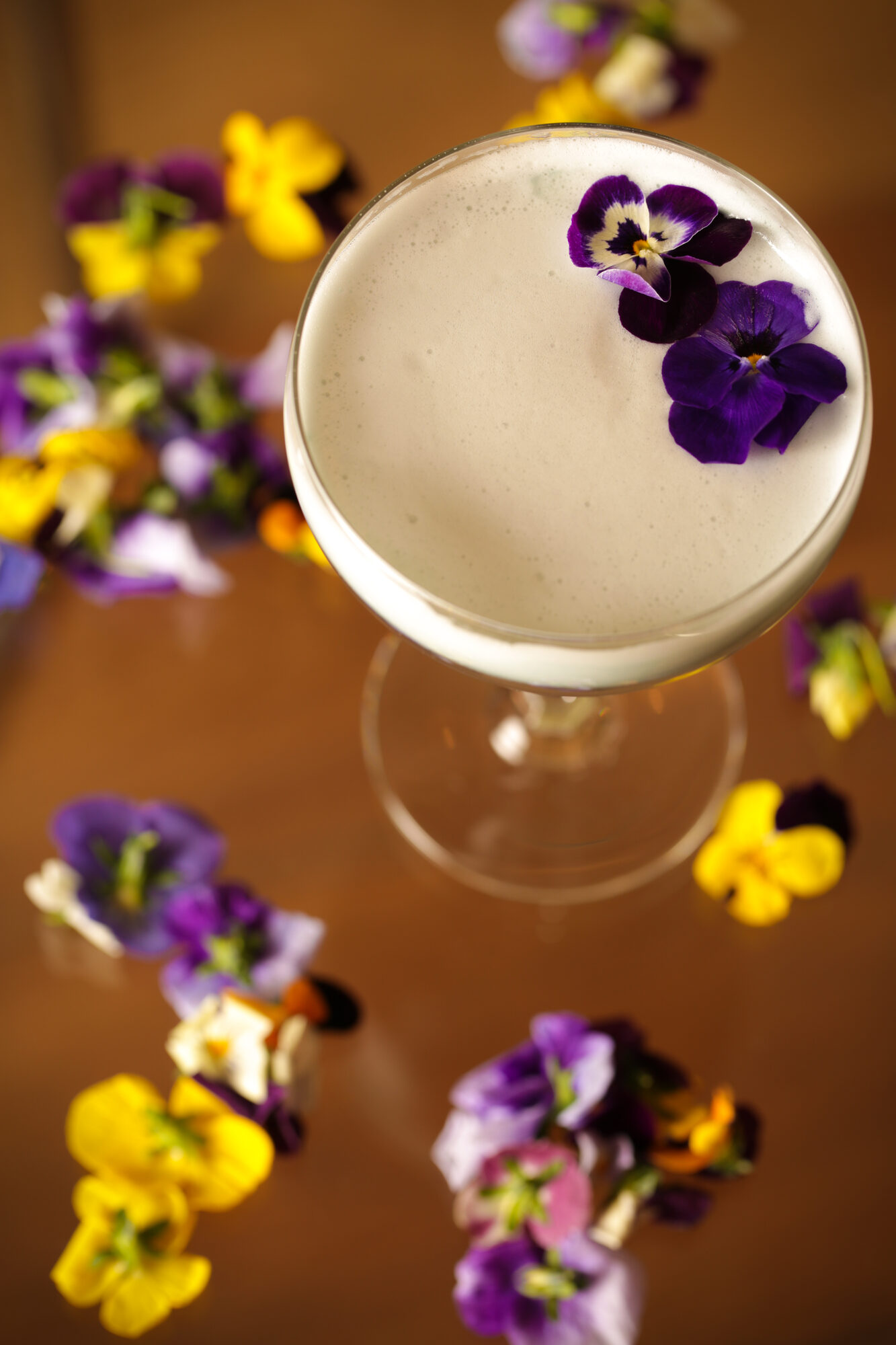 Top-down cocktail with flower garnish.