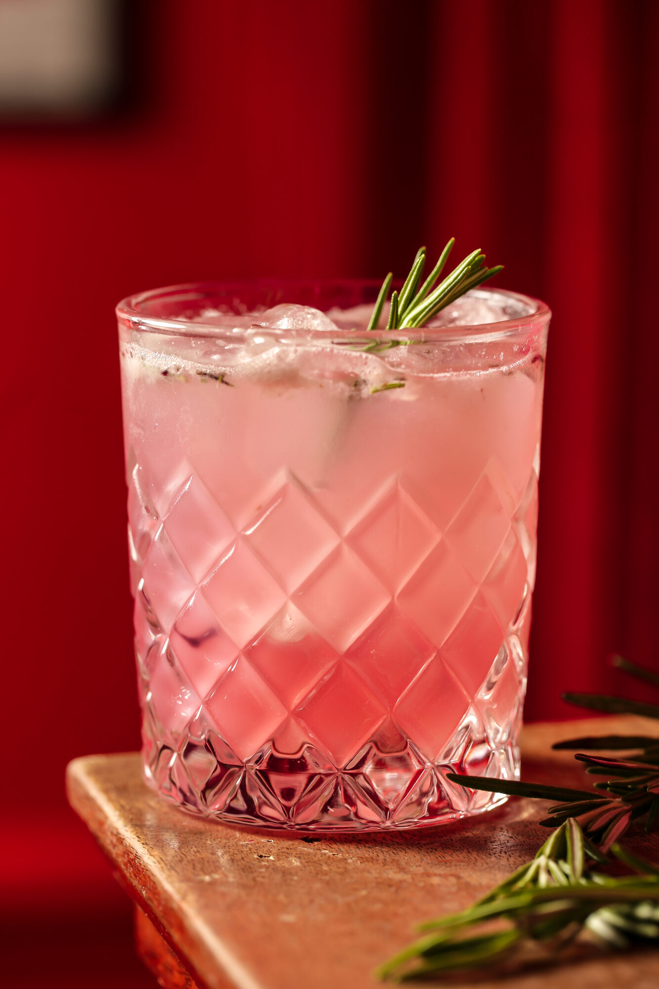 Cocktail set against the bar's red curtain.